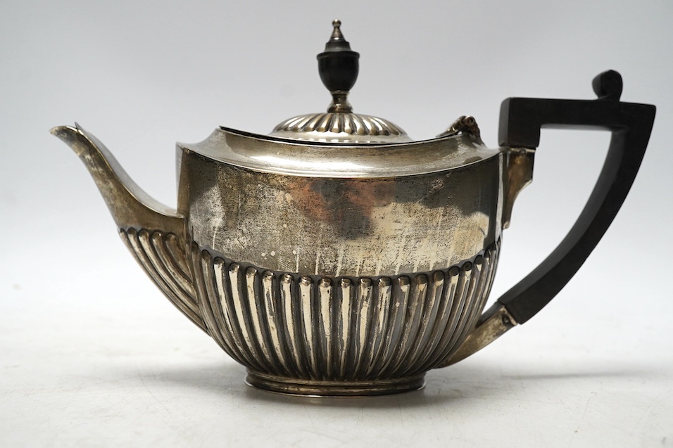 A matched late 19th/early 20th century demi-fluted silver three piece tea set, London, 1884 and later, gross weight 15.5oz. Condition - poor to fair